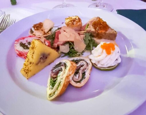 A white plate with a selection of appetisers on it.