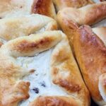 A close-up of a pie filled with sweet cheese and raisins