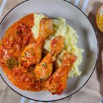 Romanian Chicken and Roast Peppers Stew Recipe – Tocanita de Pui si Ardei Copti A close-up of the stew on a gray plate.