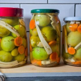 Pickled green tomatoes in jars