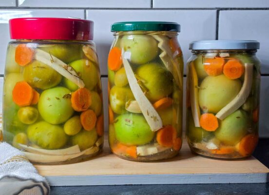 Pickled green tomatoes in jars